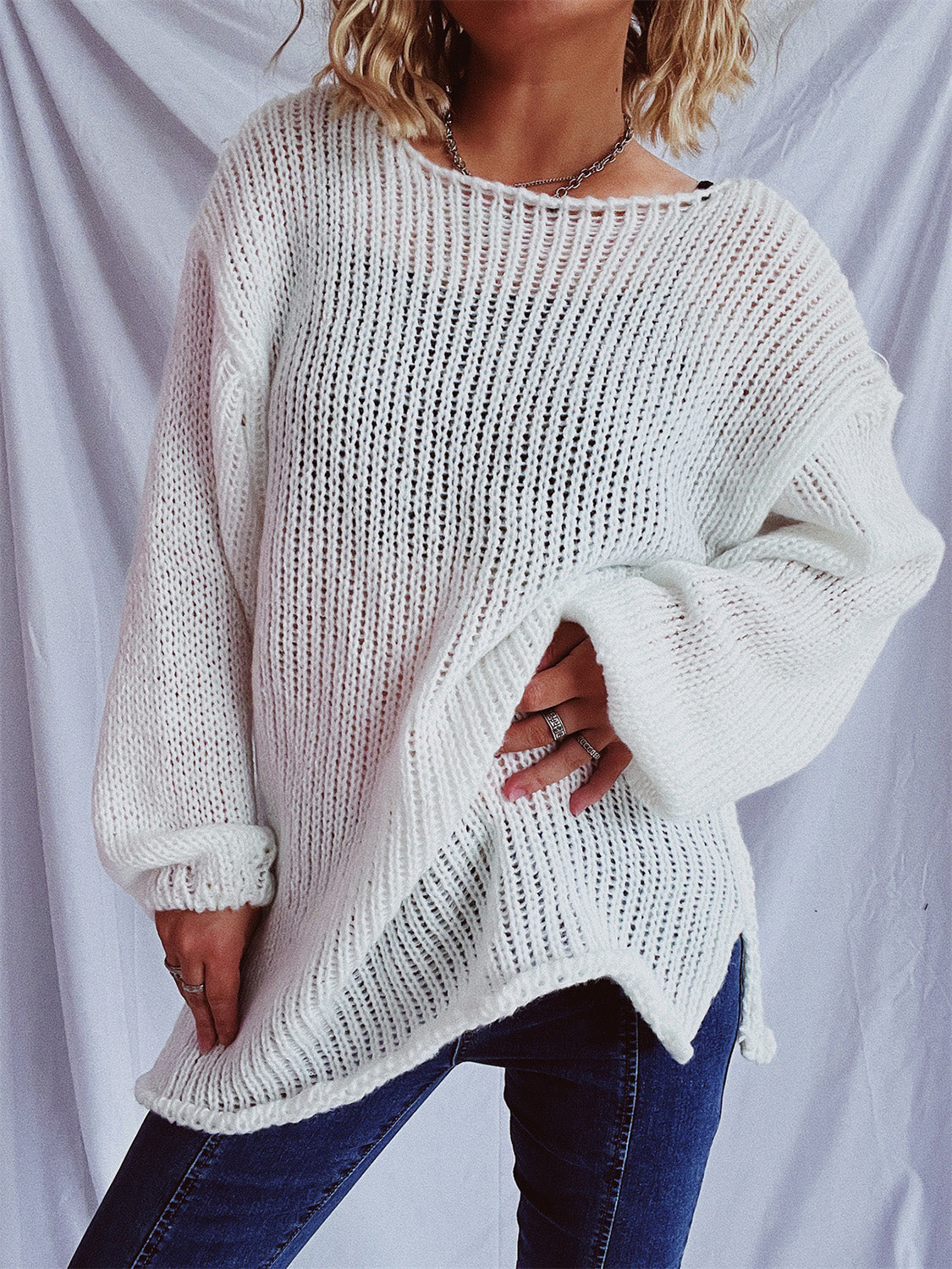 White open-knit slouchy boatneck pullover sweater with wide sleeves and a relaxed fit.