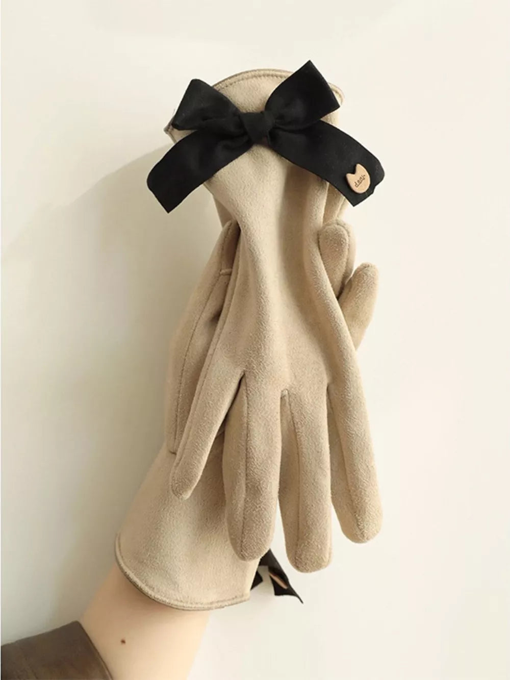 Camel gloves with black bow detail and charm