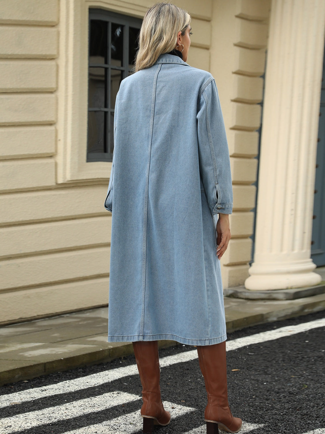 Light blue oversized denim duster jacket with buttoned cuffs and a long cut.