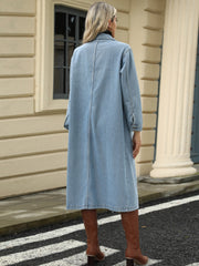 Light blue oversized denim duster jacket with buttoned cuffs and a long cut.