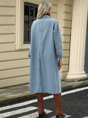 Light blue oversized denim duster jacket with buttoned cuffs and a long cut.