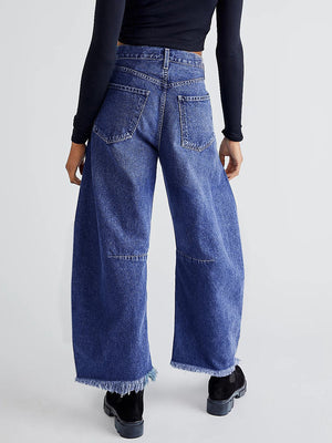 Frayed hemline palazzo jeans in medium wash denim with a wide leg and raw hem detail.