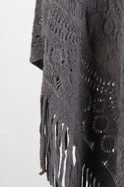 Dark gray crochet poncho with openwork patterns and fringe detail.