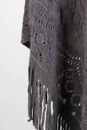 Dark gray crochet poncho with openwork patterns and fringe detail.