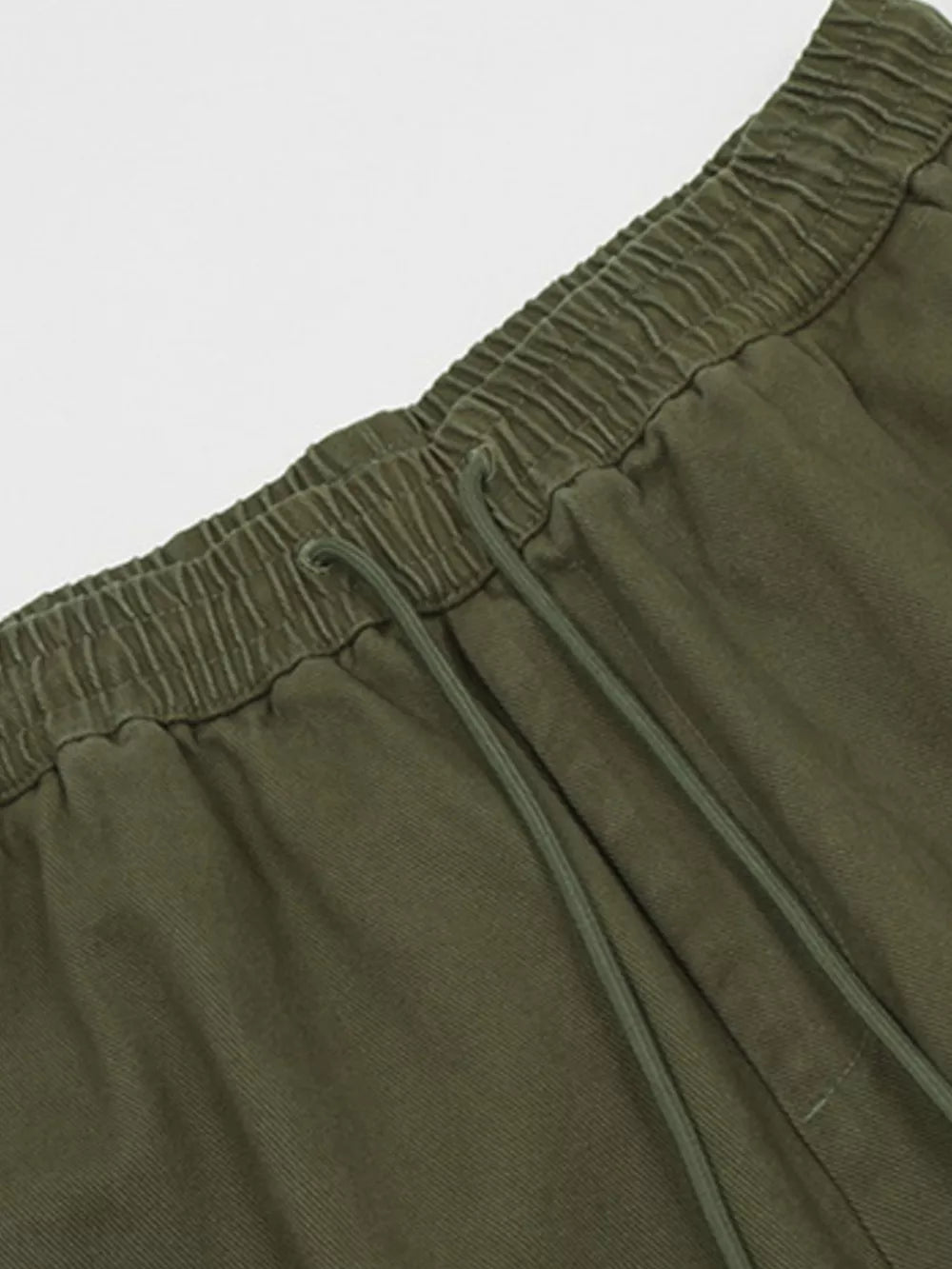 Olive green cargo pants with elastic waistband and adjustable drawstring