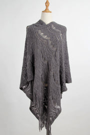 Dark gray textured crochet poncho with fringe and open knit pattern