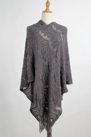 Dark gray textured crochet poncho with fringe and open knit pattern