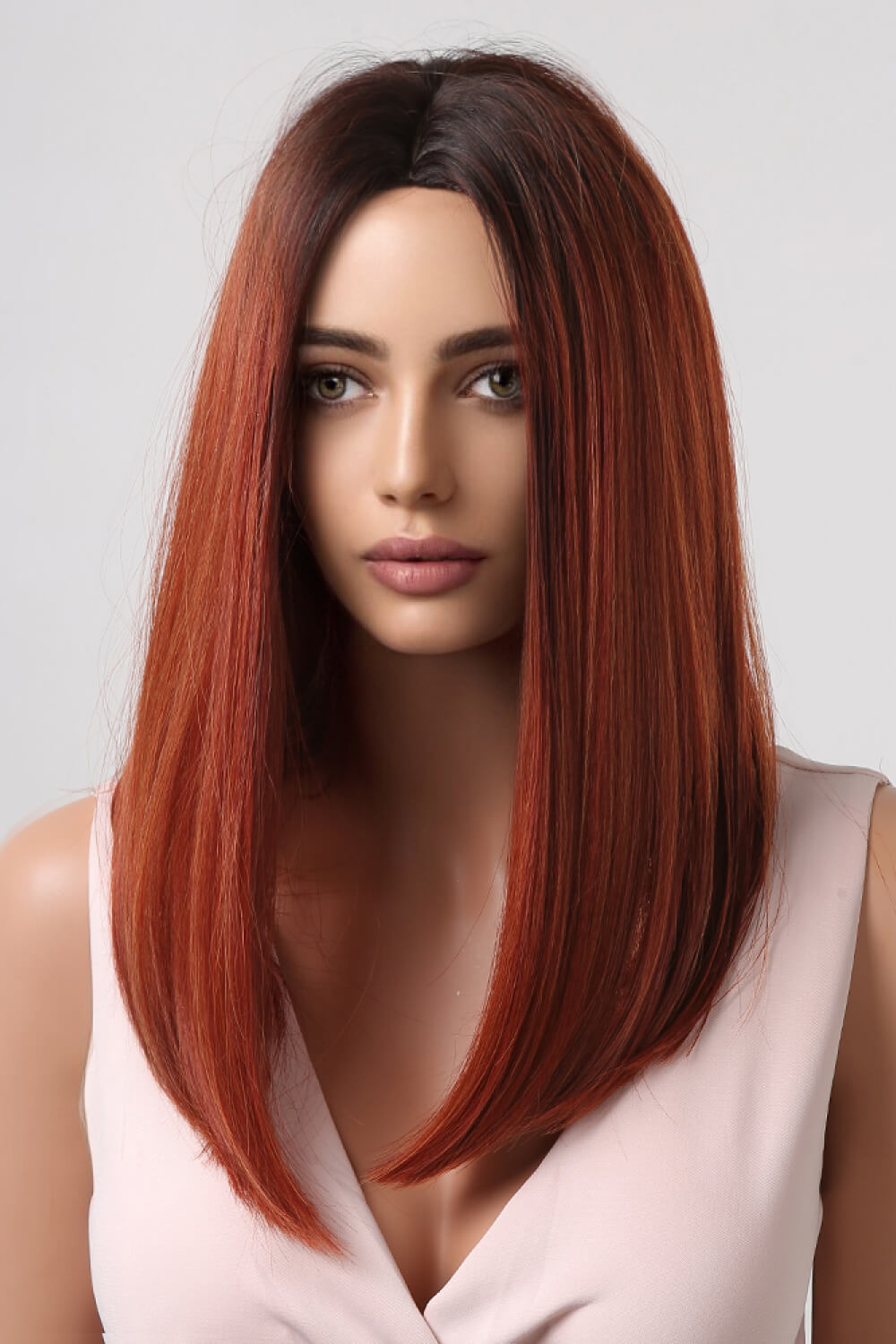 Auburn ombre wig with a center part and dark roots, styled straight.
