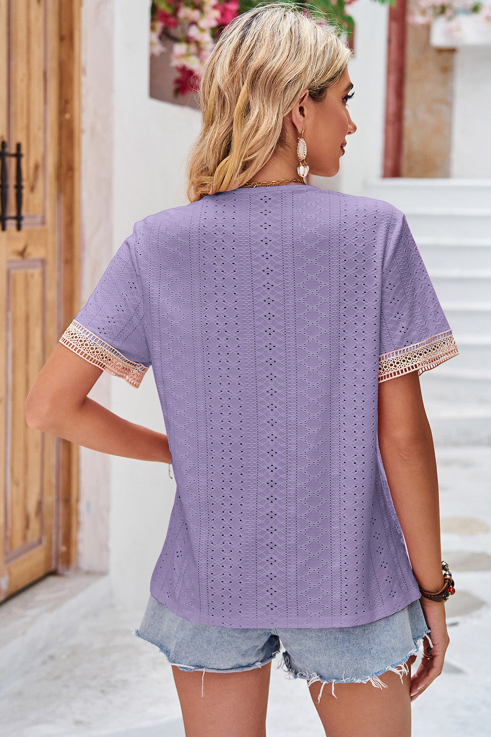 Lavender eyelet blouse with lace trim on short sleeves and V-neck.