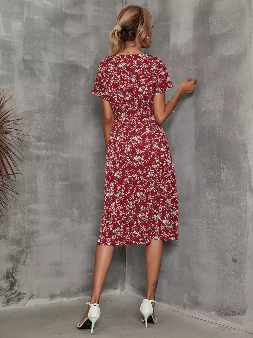 Wine red midi dress with a vibrant leaf pattern, V-neck, short sleeves, and an A-line cut.