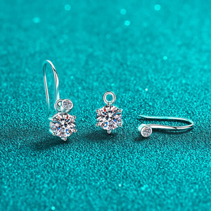 Silver drop earrings with clear solitaire stones and a matching ear cuff.