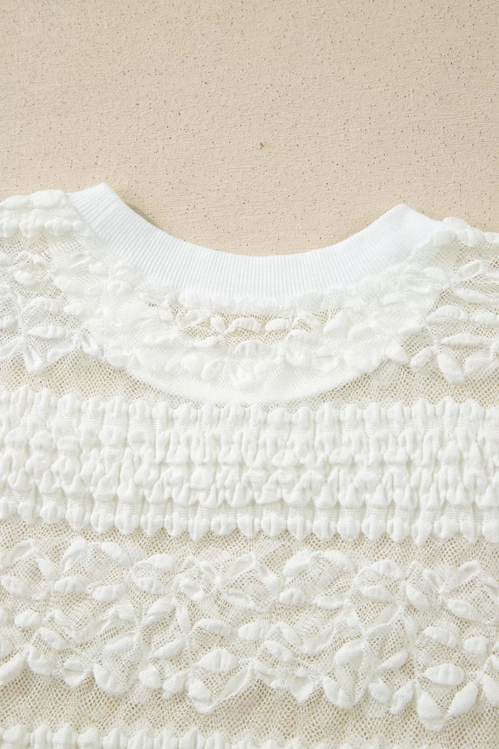 White sheer t-shirt with lace patchwork and textured fabric details.