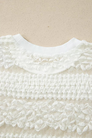 White sheer t-shirt with lace patchwork and textured fabric details.