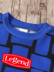 Children's blue graphic tee with abstract block pattern and red "Legend" patch detail.