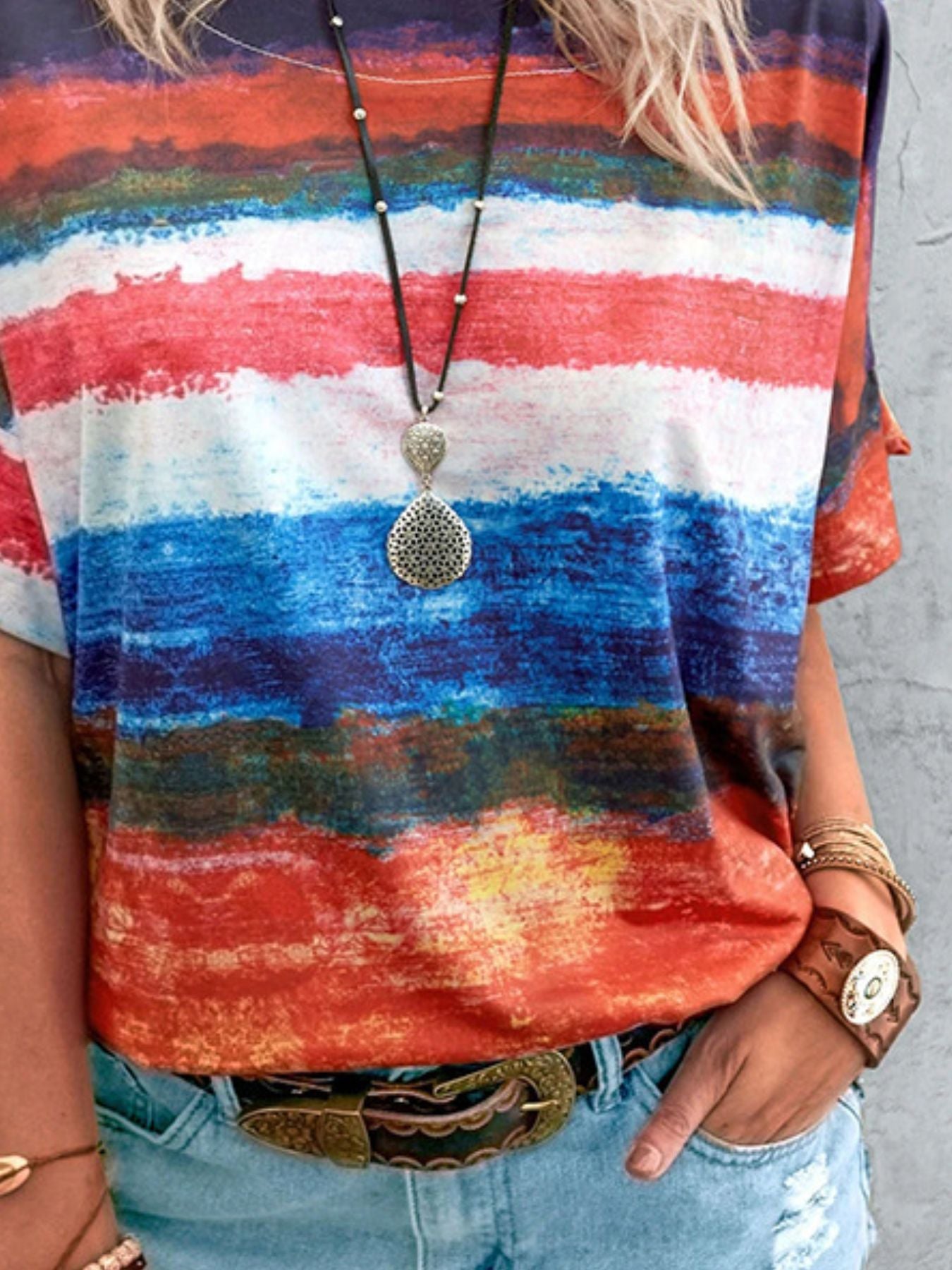 Casual t-shirt with brushstroke stripes in red, white, blue, and orange.
