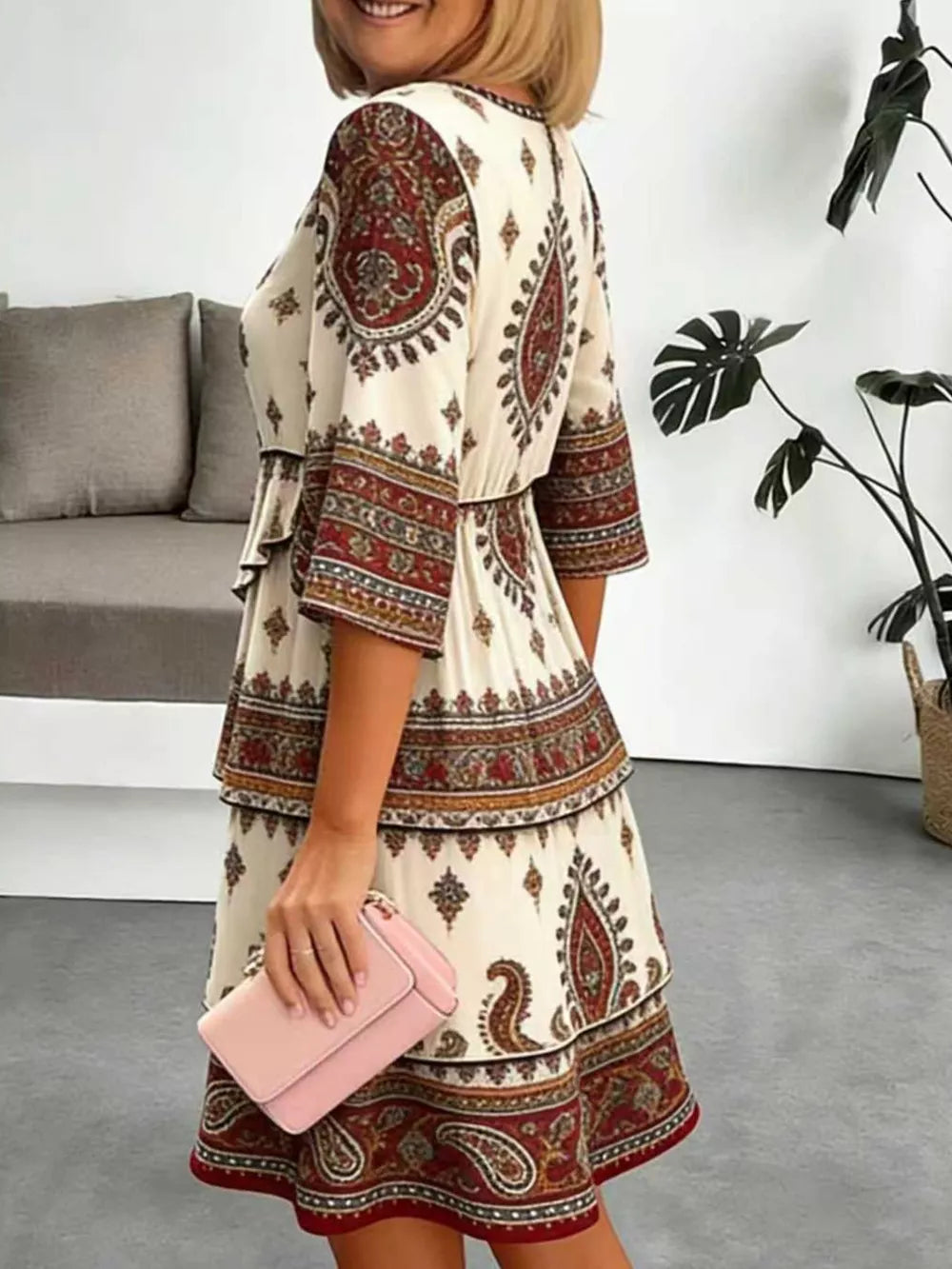 Paisley print mini dress with ruffle tiers and 3/4 sleeves.