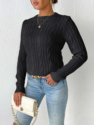 Black cable knit mock neck sweater with long sleeves.