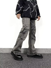 Men's relaxed fit washed flare jeans in grey denim with distressed details and paneling.