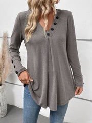 Gray button-placket tunic with subtle front pleats and button cuffs.