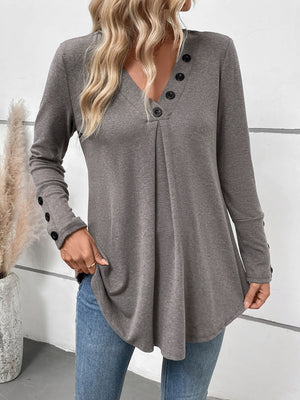 Gray button-placket tunic with subtle front pleats and button cuffs.