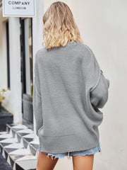 Oversized grey knit V-neck sweater with a slouchy fit and ribbed hem.