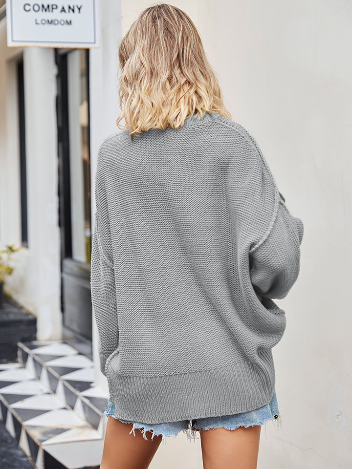 Oversized grey knit V-neck sweater with a slouchy fit and ribbed hem.