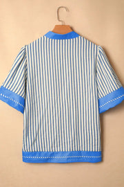 Blue and white striped shirt with decorative stitching and color block accents.