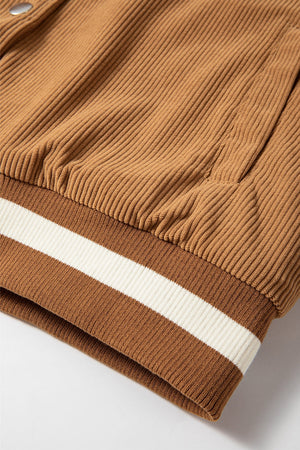 Terracotta corduroy bomber jacket with ribbed knit cuffs featuring contrast stripes.
