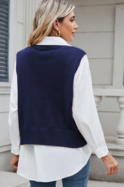 Dark Navy cable knit vest over a white button-down shirt.