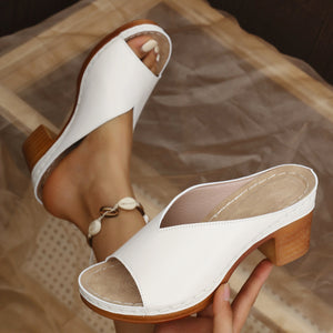 Off White open-toe block heel sandals with a V-shaped vamp and wooden heel.