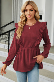Burgundy textured peplum blouse with ruffle detail and long sleeves
