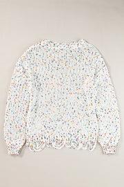 White confetti knit sweater with distressed hem and colorful flecks.