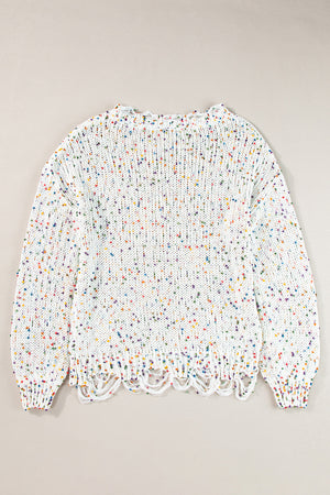 White confetti knit sweater with distressed hem and colorful flecks.