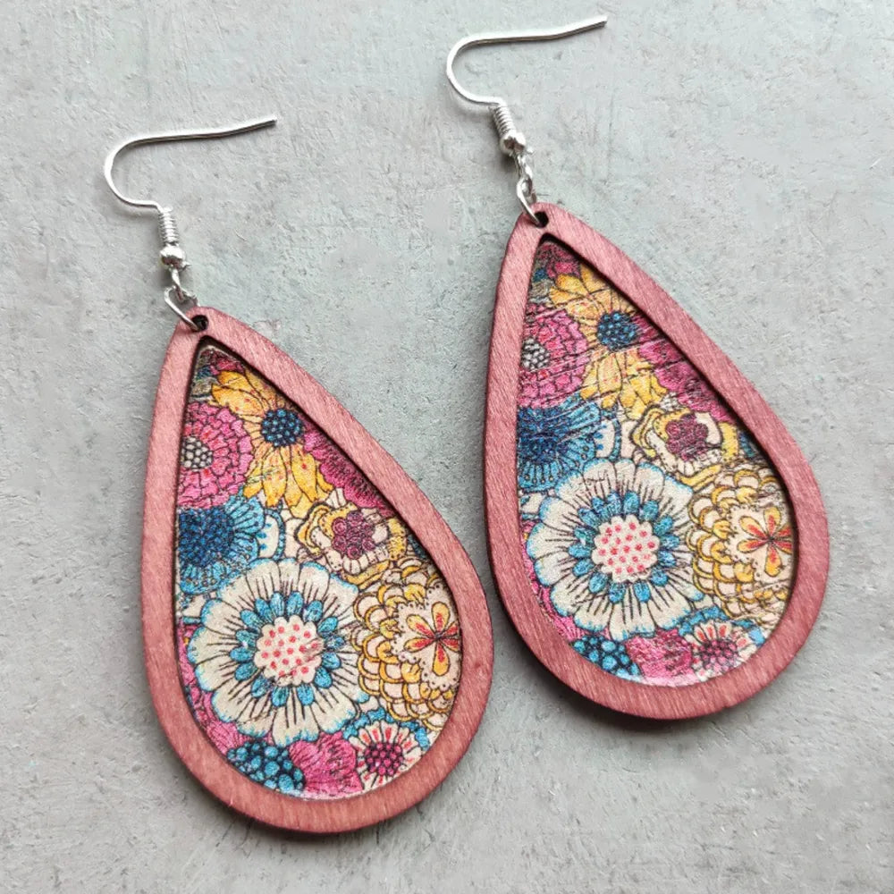 Teardrop woodgrain earrings with a colorful floral print in dusty pink.