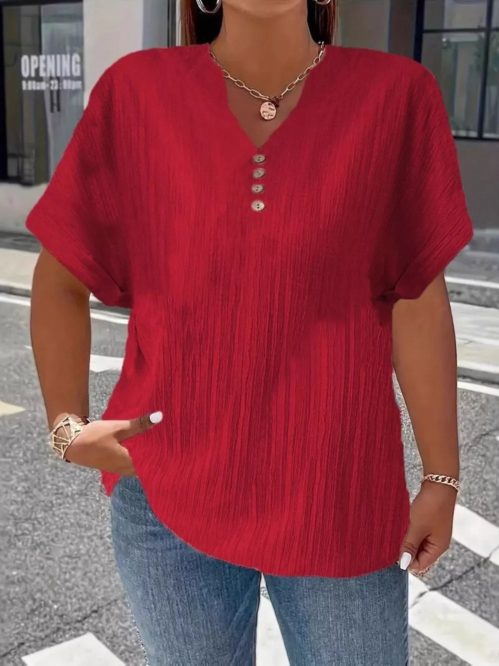 Red textured plus size v-neck t-shirt with decorative buttons and short sleeves.