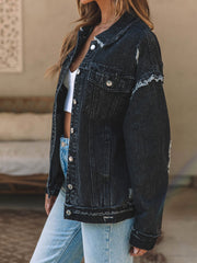 Black denim trucker jacket with raw hem and distressed details.