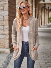 Tan textured ribbed open-front cardigan with pockets, styled with a white tank and jeans.