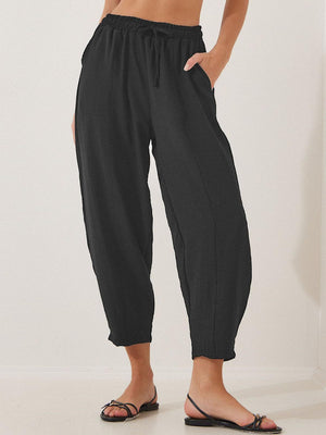 Black balloon trousers with drawstring waist and sculpted seamline detail