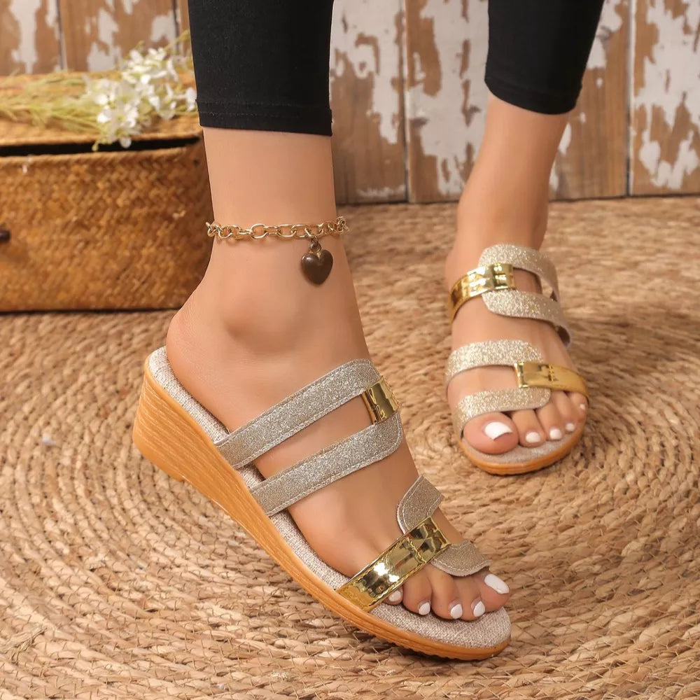 Glistening dual-strap wedge sandals in gold and silver with wooden heel.