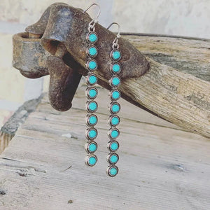 Turquoise stone cascade earrings with silver alloy settings.