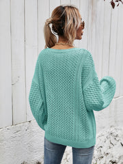 Teal open-knit sweater with balloon sleeves and a diamond pattern.