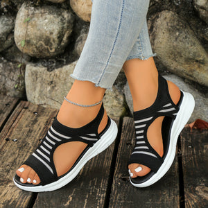 Black and white striped cutout sandals with a chunky sole.