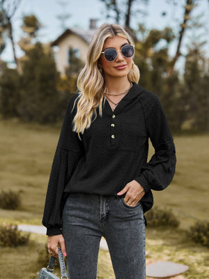 Black textured knit henley with balloon sleeves and button detail