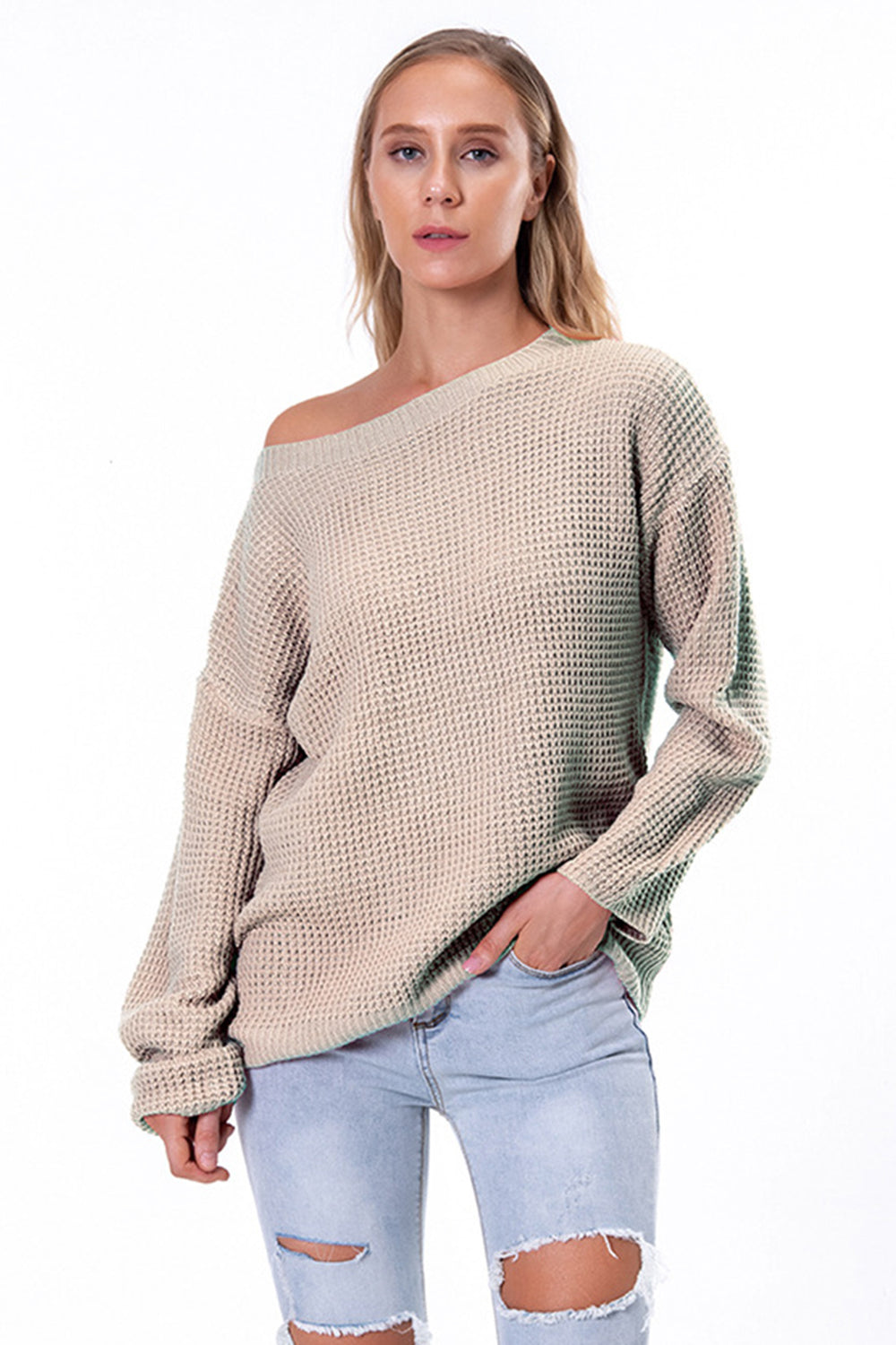 Off-shoulder waffle knit sweater in beige with slouchy fit and boat neck.
