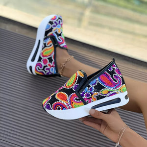 Paisley print platform slip-on shoes with a chunky white sole.