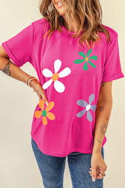Hot pink t-shirt with a casual fit and a colorful daisy graphic print.
