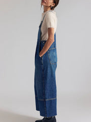 Light blue denim overalls with wide legs and raw hem detail.