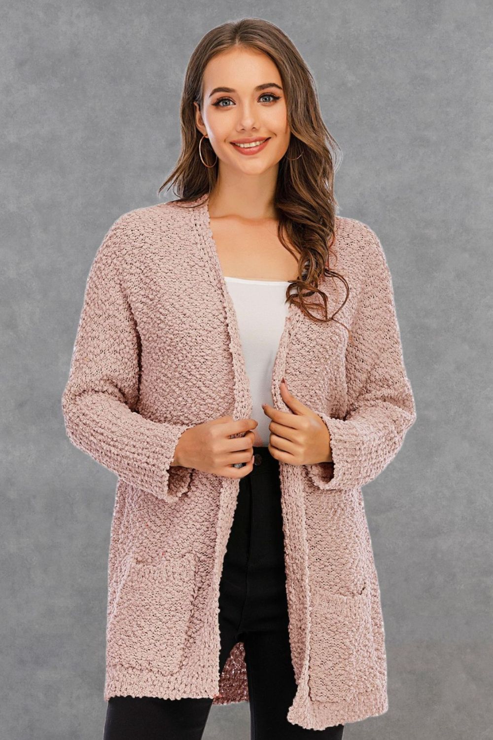 Textured cocoon cardigan in watermelon pink with patch pockets and an open front.