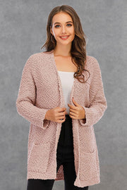 Textured cocoon cardigan in watermelon pink with patch pockets and an open front.