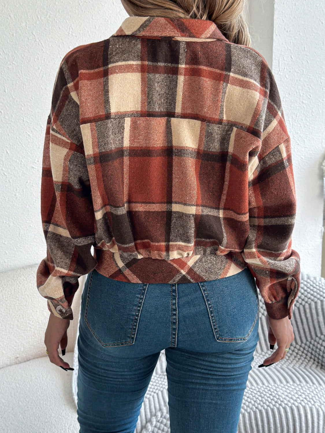Cropped plaid shacket in terracotta with gathered sleeves and button detail.